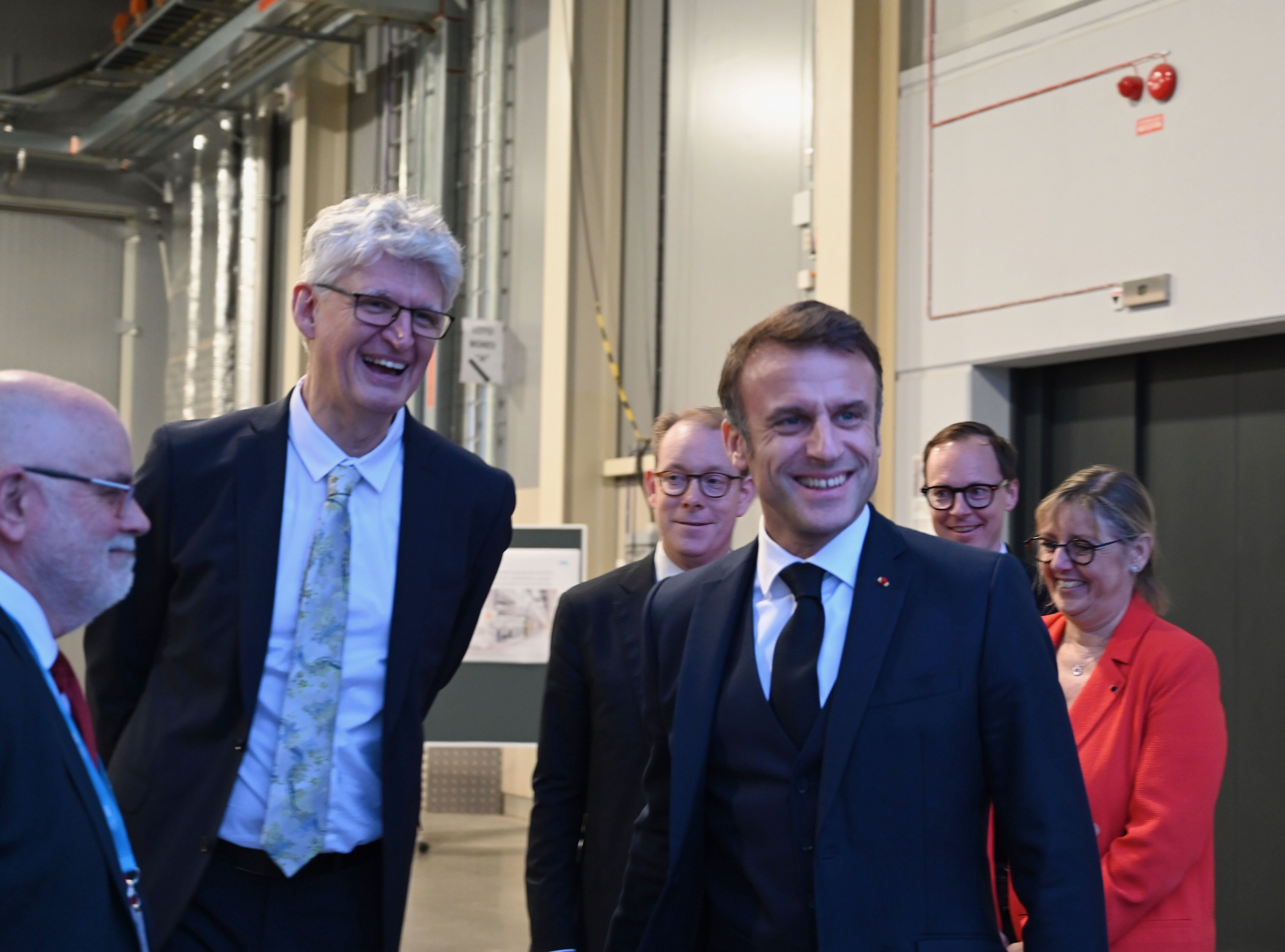 Helmut Schober smiles next to a smiling President Macron