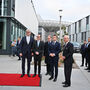 ESS Director General Helmut Schober stands to the left of the King of Sweden, French President Emmanuel Macron, Swedish Minister of Education Mats Persson and Minister of Foreign Affairs Tobias Billström, by a red carpet outside the shiny glass office buildings of ESS
